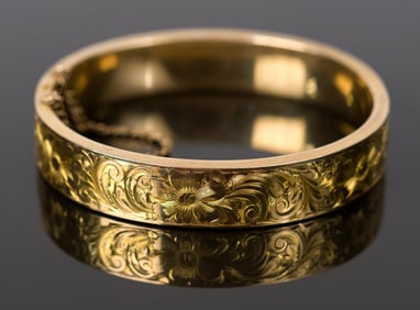 VINTAGE ENGRAVED 14K GOLD HINGED BANGLE BRACELET.