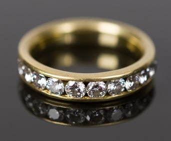 18K YELLOW GOLD CHANNEL SET DIAMOND BAND.