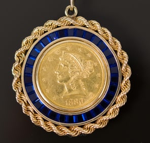 1880 $5 LIBERTY GOLD COIN IN SYN. SAPPH. FRAME.