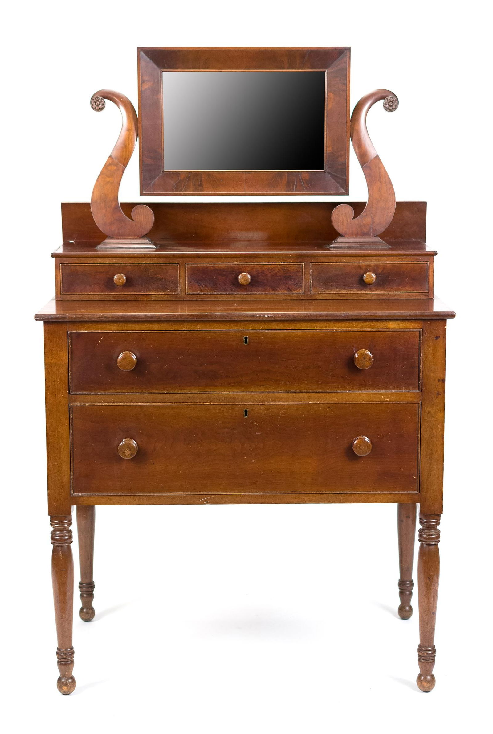 FEDERAL MAHOGANY DECK TOP DRESSING TABLE.: Ca. 1820-1830, Federal mahogany dressing table with deck top, an attached mirror, carved lyre harps, and three drawers. Lower section with two dovetailed drawers on turned legs. 64”H x 39”