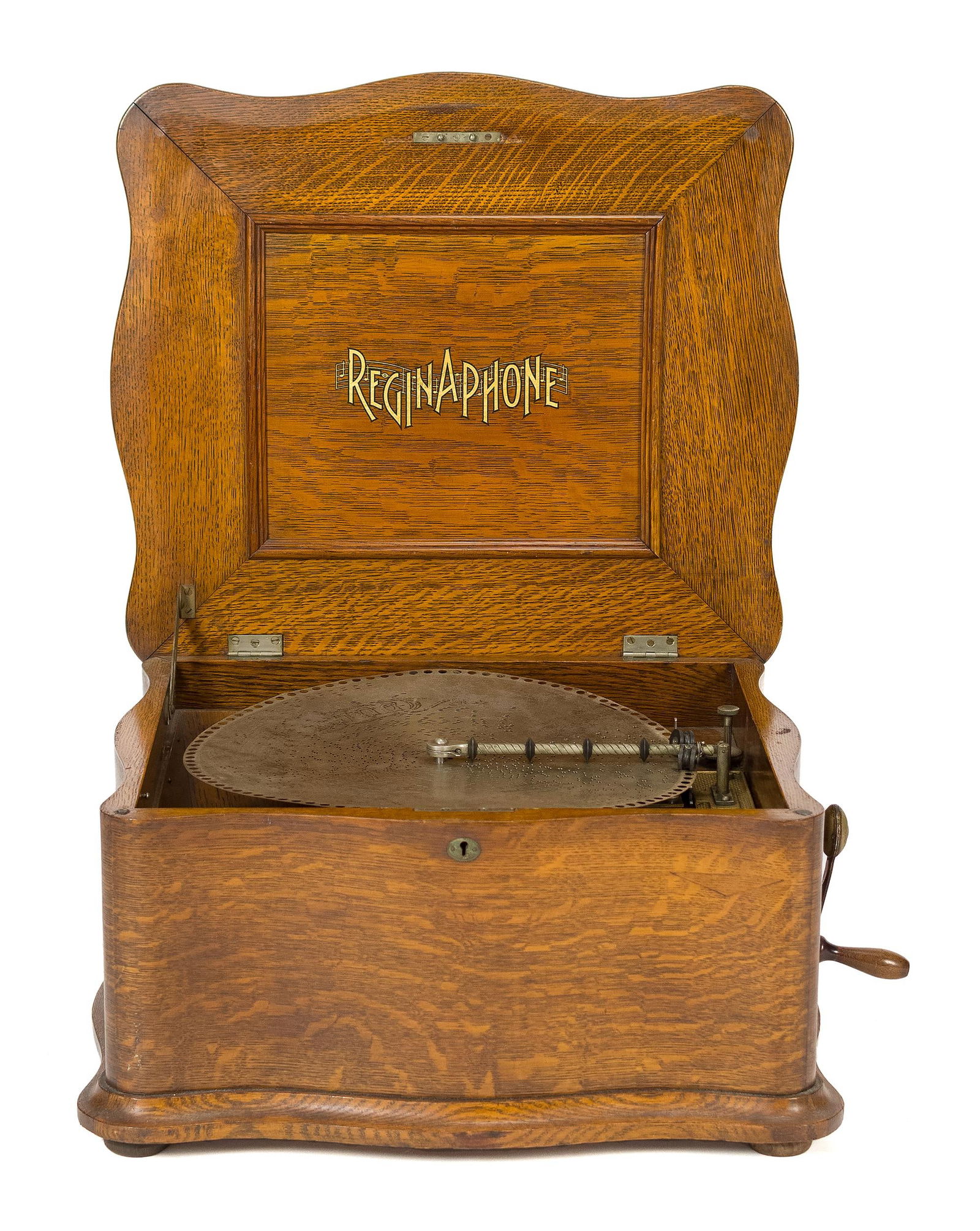 ANTIQUE REGINAPHONE DISC MUSIC BOX.: A ReginaPhone table top disc music box, in a serpentine oak case, with two 15.5” discs. 13”H x 21.5”W x 19”D.