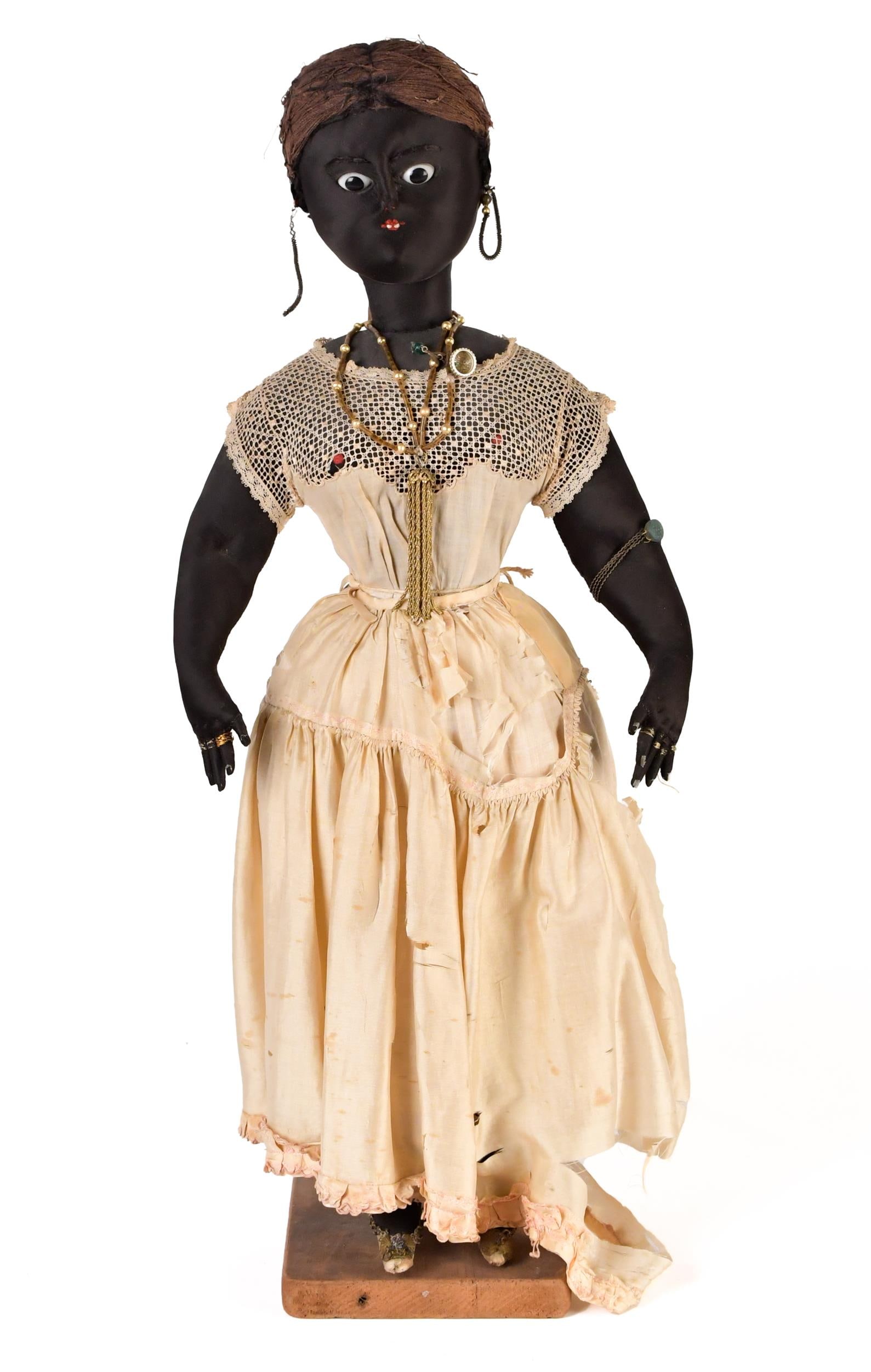 GOOD ANTIQUE FULL FIGURE DOLL.: A wonderful antique full figure standing cloth doll, woman adorned in jewelry, displayed in glass showcase. Doll 24”H x 10”W.