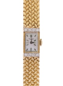 LADY'S BAUME & MERCIER 14K GOLD DIAMOND WRIST WATCH.