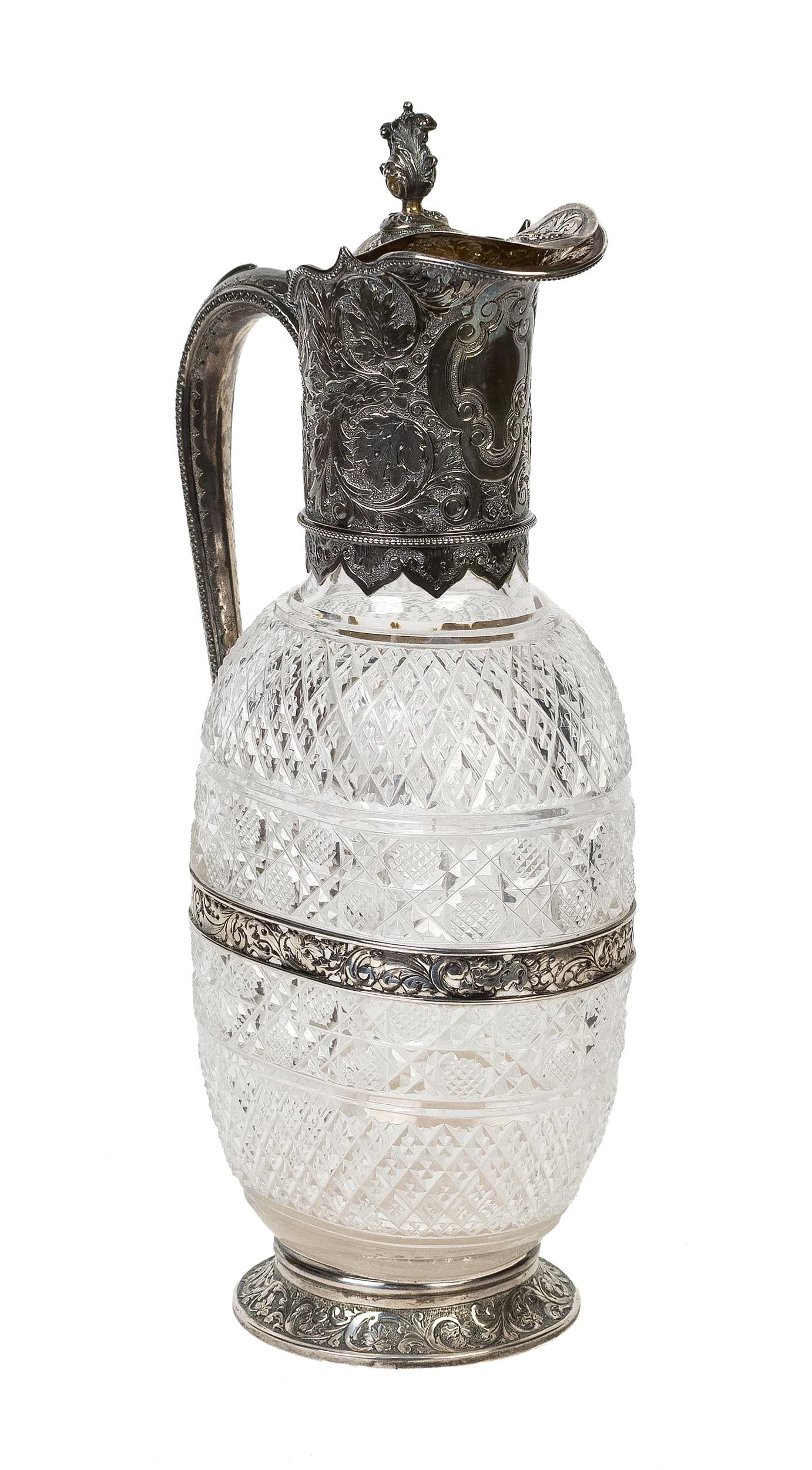 19TH C. HORACE WOODWARD ENGLISH STERLING CLARET JUG.: A late 19th C. cut crystal and sterling mounted handled claret jug, hallmarked ‘EFHT’, the work of Horace Woodward, 13”H.