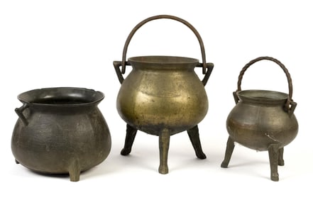 THREE EARLY BRONZE FOOTED KETTLES.