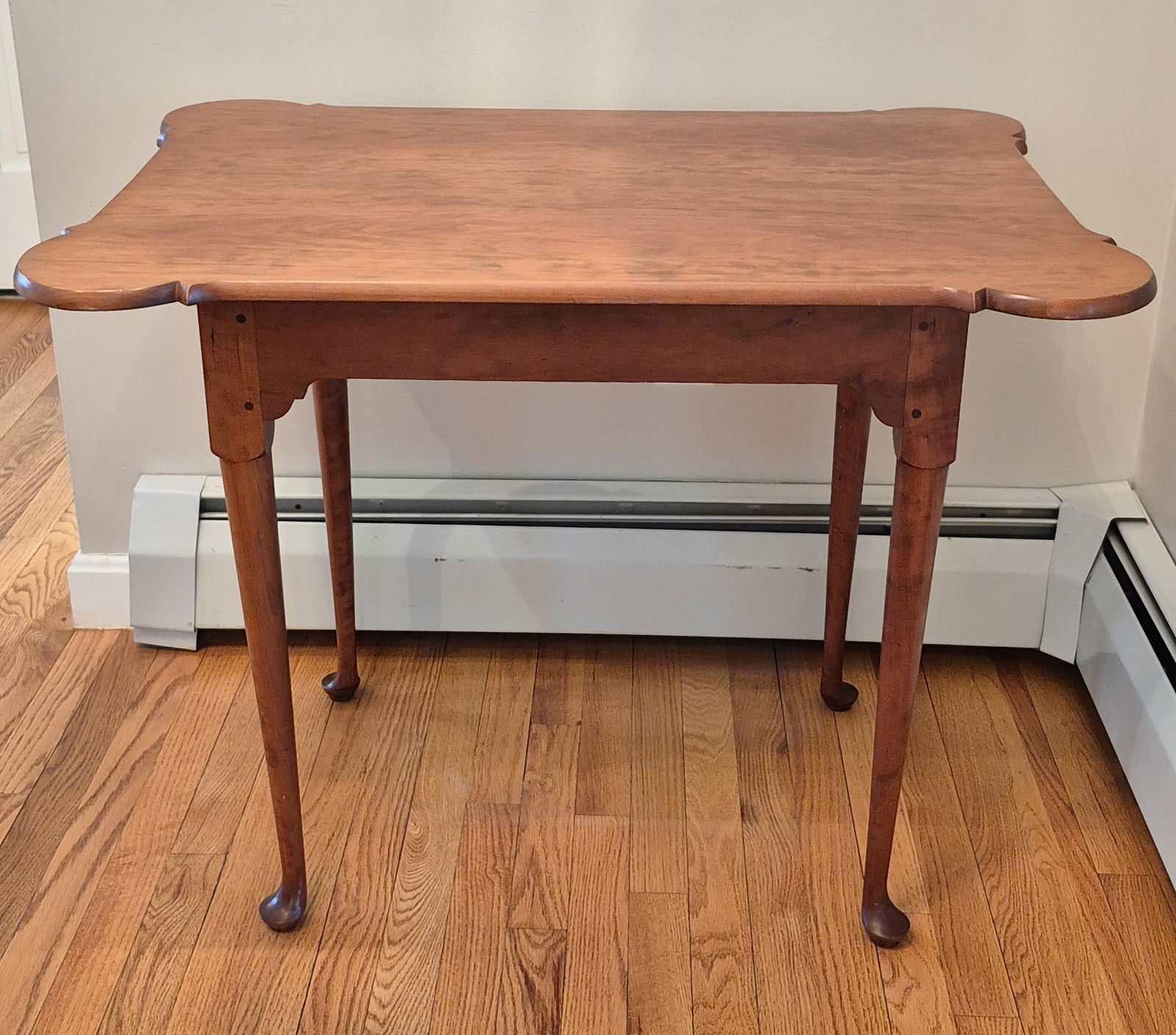 JEFFREY GREENE CHERRY TEA TABLE.: A Jeffrey Greene (RI) labeled and signed cherry Queen Anne style tea table with a porringer shaped top on cabriole legs. 27”H x 34.5”H x 24”D.