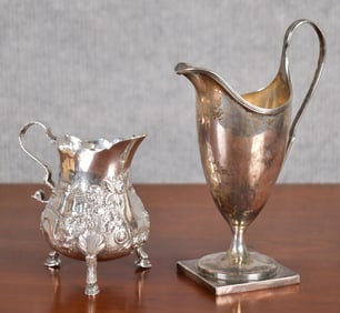 TWO ANTIQUE SILVER CREAM JUGS.