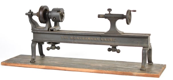 ANTIQUE MONTGOMERY CAST IRON LATHE.