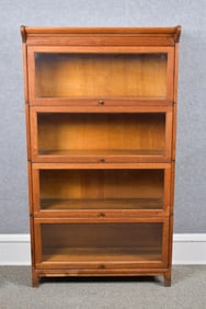 ANTIQUE FOUR SECTION OAK BARRISTER BOOKCASE.
