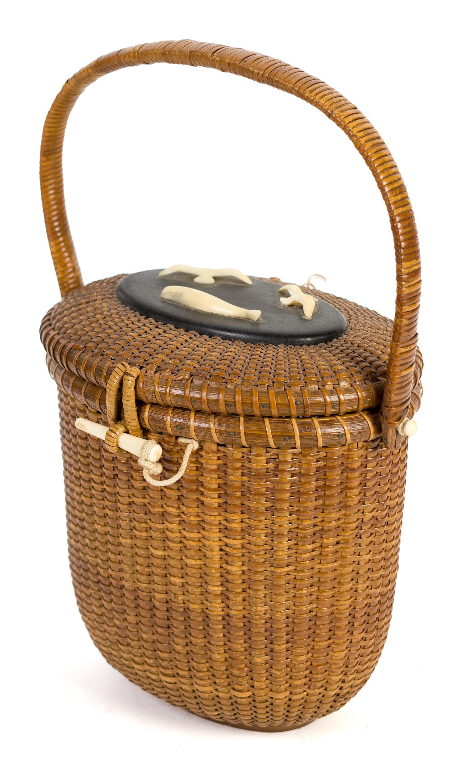 ANTIQUE REYES NANTUCKET LIGHTSHIP BASKET PURSE.: An antique early 20th C. Jose Reyes signed Nantucket lightship woven basket purse with swing handle and lid carved with bird and whale figures, mounted on rosewood plaque. 7.5”H x 7.5”W.