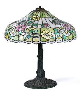 ANTIQUE CHICAGO MOSAIC TABLE LAMP.: A 1900-1910 Chicago Mosaic table lamp with leaded glass floral shade, on bronze patinated metal tree form base. 28”H x 23” dia. shade.