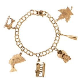 VINTAGE 14K GOLD CHARM BRACELET.