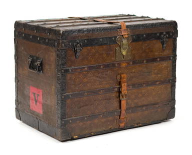 ANTIQUE LOUIS VUITTON TRUNK.: An antique Louis Vuitton ‘LV’ monogrammed canvas wrapped and wood bound flat top steamer trunk. Serial number 117 900. 22.5”H x 30”W x 19.5”D.