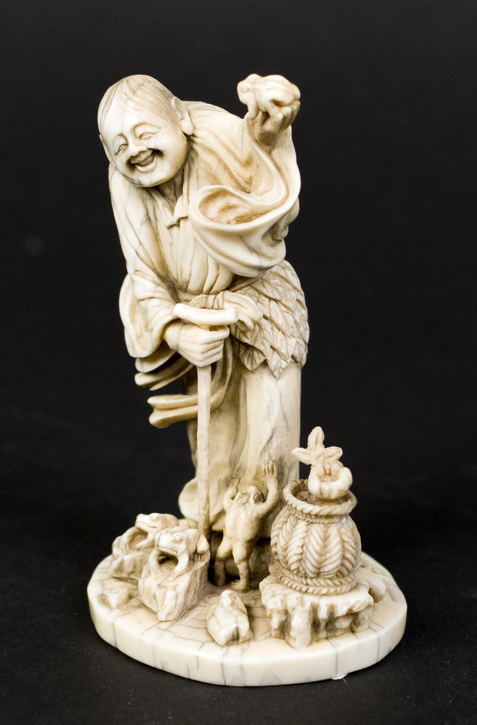 JAPANESE MEIJI BONE CARVING, OLD MAN.: A good Japanese Meiji Okimono bone carving of an old man with frogs, inset with a mother-of-pearl plaque with artist signature. 3.25”H.