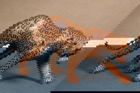VINTAGE LEATHER WRAPPED LEOPARD.: A vintage leather wrapped leopard with painted spots, 21”H x 50”L.