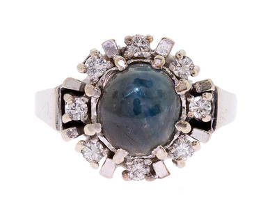 VINTAGE 14K GOLD STAR SAPPHIRE & DIAMOND RING.: A vintage, 14k white gold (stamped) ring set with approx. 3.84 ct. oval cabochon, medium dark blue (with a yellowish green spot) sapphire, and approx. .25 ct. tw. round brilliant cut, natural
