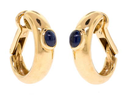 FRENCH 18K GOLD CHAUMET PARIS SAPPHIRE CLIP EARRINGS.: A pair of French, 18k yellow gold (stamped), clip earrings marked Chaumet Paris, 108980, set with approx. .40 ct. tw. cabochon oval, dark blue sapphire, 3/4 inches long, 12.6 grams.
