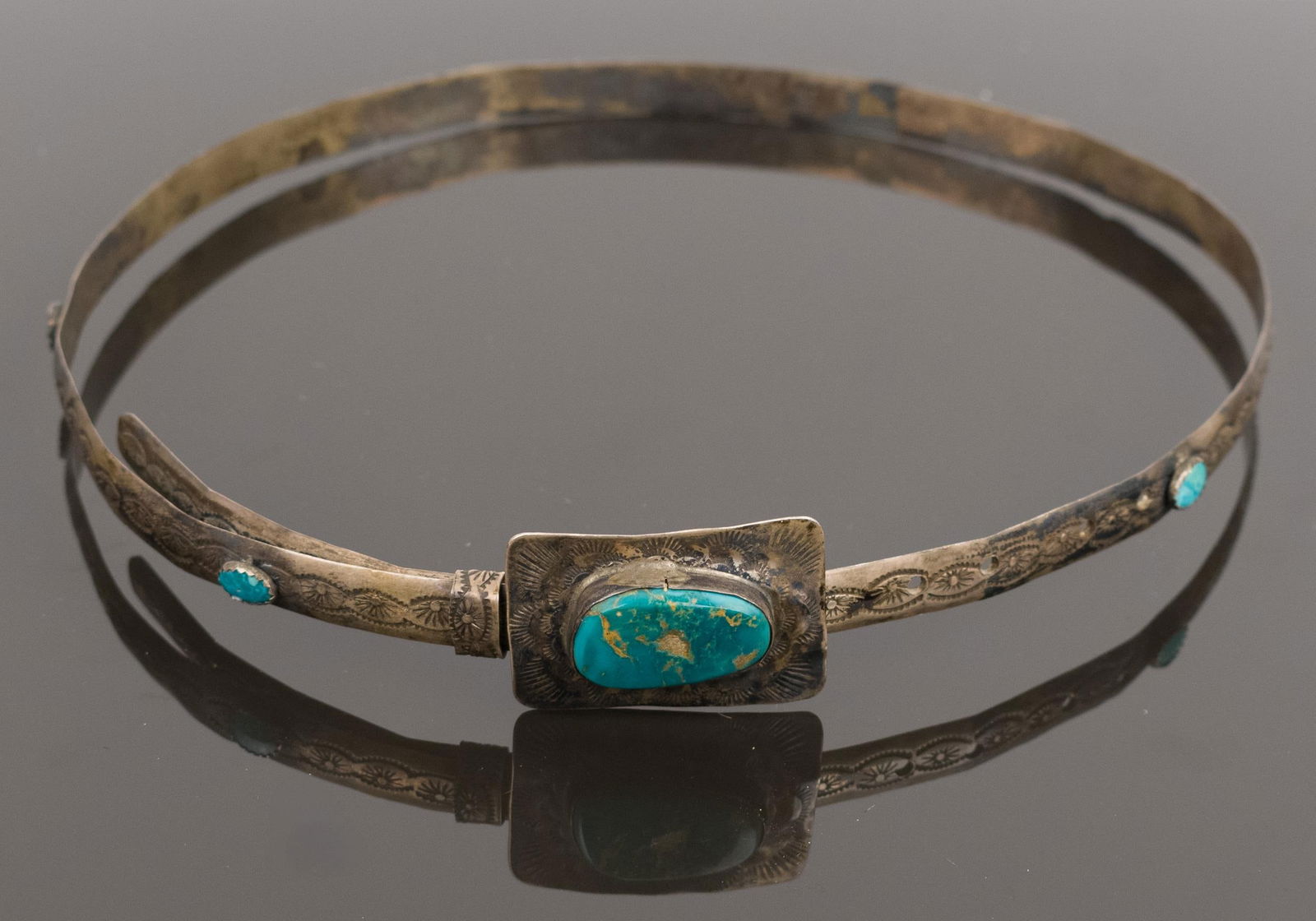 NATIVE AMERICAN STERLING TURQUOISE HAT BAND.: A sterling silver (tested), handmade, Native American, hat band set with turquoise, centerpiece is 1 3/4 inches long, approx. 26 inch diameter (adjustable), 99 grams. Provenance: Carl Moon estate.