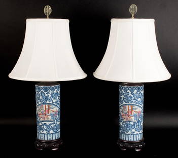 PR. 20TH C. CHINESE PORCELAIN LAMPS.: A pair of 20th C. cylindrical Chinese porcelain table lamps, with polychrome famille rose cartouches. Porcelain 11.5&#8221;, overall 30&#8221;H.