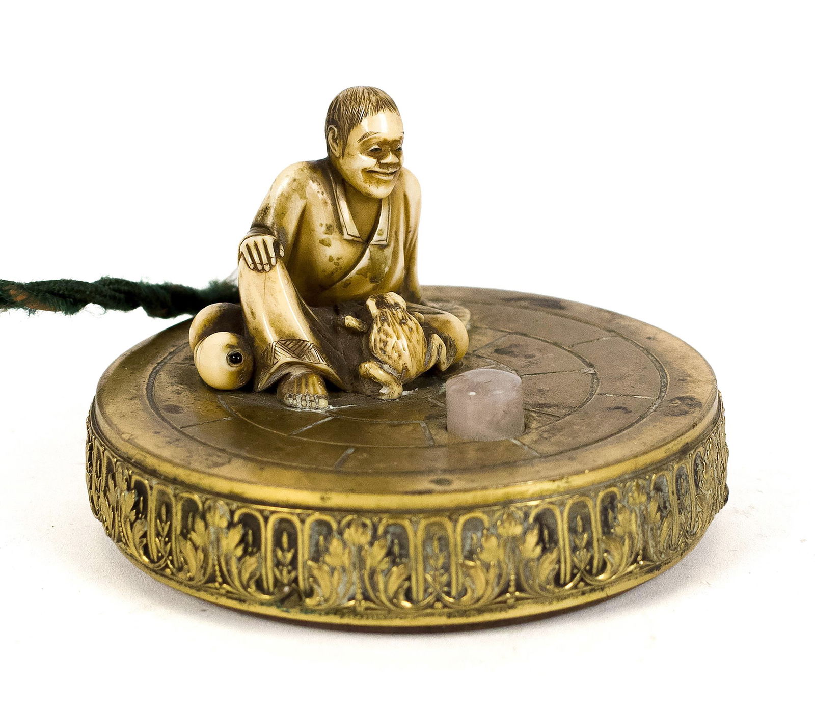 MEIJI PERIOD BUTLERS BELL.: A Japanese Meji period butler's bell, with a carved bone sitting figure depicting a frog, on a brass base, with a pink quartz push button. 3” dia. x 2”H.