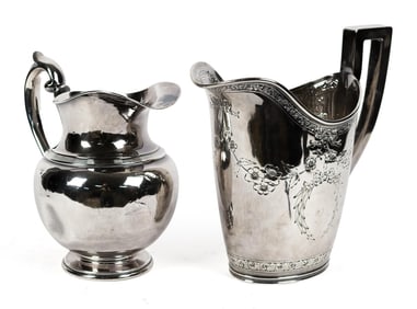 TWO STERLING SILVER WATER PITCHERS.