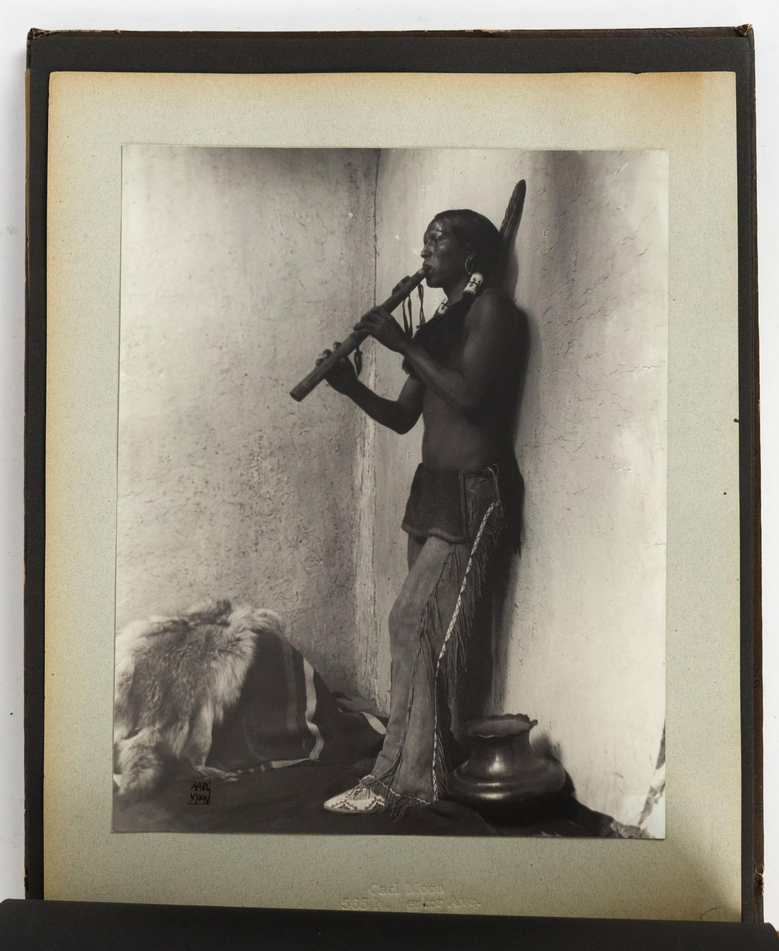 CARL MOON STUDIO CATALOGUE FOLIO.: A Carl Moon studio catalogue, with 15 black and white photographs, each titled in table of contents at beginning, contained in an embossed leather folio. All with ink signature of artist, and attached