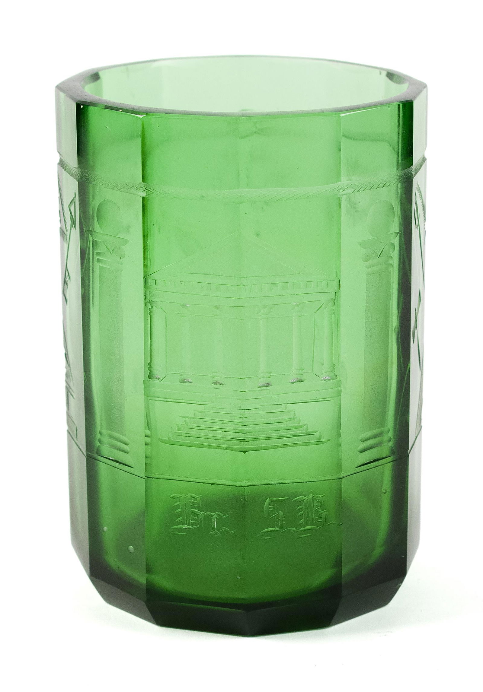 EARLY 19TH C. GREEN GLASS MASONIC JAR.: An early 19th C. green glass jar, with etched Masonic designs, including temple, swords, eye, sun, and more. 6”H x 4.25”dia.