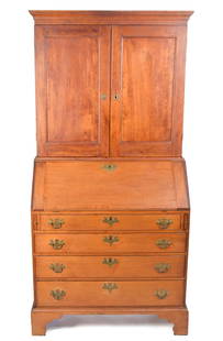 18TH C. CHIPPENDALE NEW ENGLAND SECRETARY.: A ca. 1780 two-part New England maple secretary, top section with an applied molded cornice, over two paneled doors opening to reveal three fixed shelves. Lower section with slant lid, covering an int
