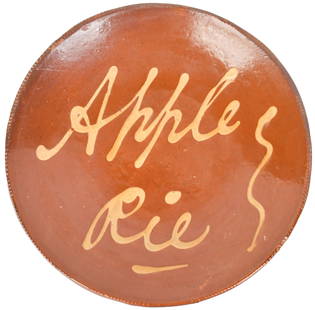 19TH C. AMERICAN REDWARE PLATE, APPLE PIE.: Likely mid-19th C., Connecticut origin, circular redware dish, decorated with yellow slip &#8216;Apple Pie&#8217;.10.25&#8221; dia.
