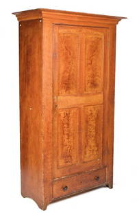 19TH C. GRAIN-PAINTED FLOOR CUPBOARD.: A mid to late 19th C. single part American grain-painted pine floor cupboard with large cornice molding over a single paneled door that reveals an open interior with no shelving over a single drawer i