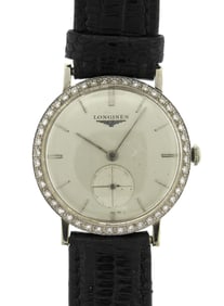 VINTAGE 18K GOLD LONGINES DIAM. BEZEL WRIST WATCH.
