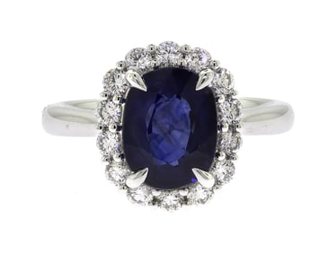 PLATINUM OVAL SAPPHIRE & DIAMOND HALO RING.