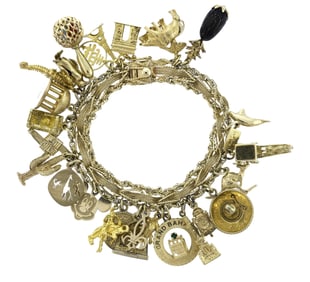 VINTAGE MOSTLY 14K GOLD CHARM BRACELET.