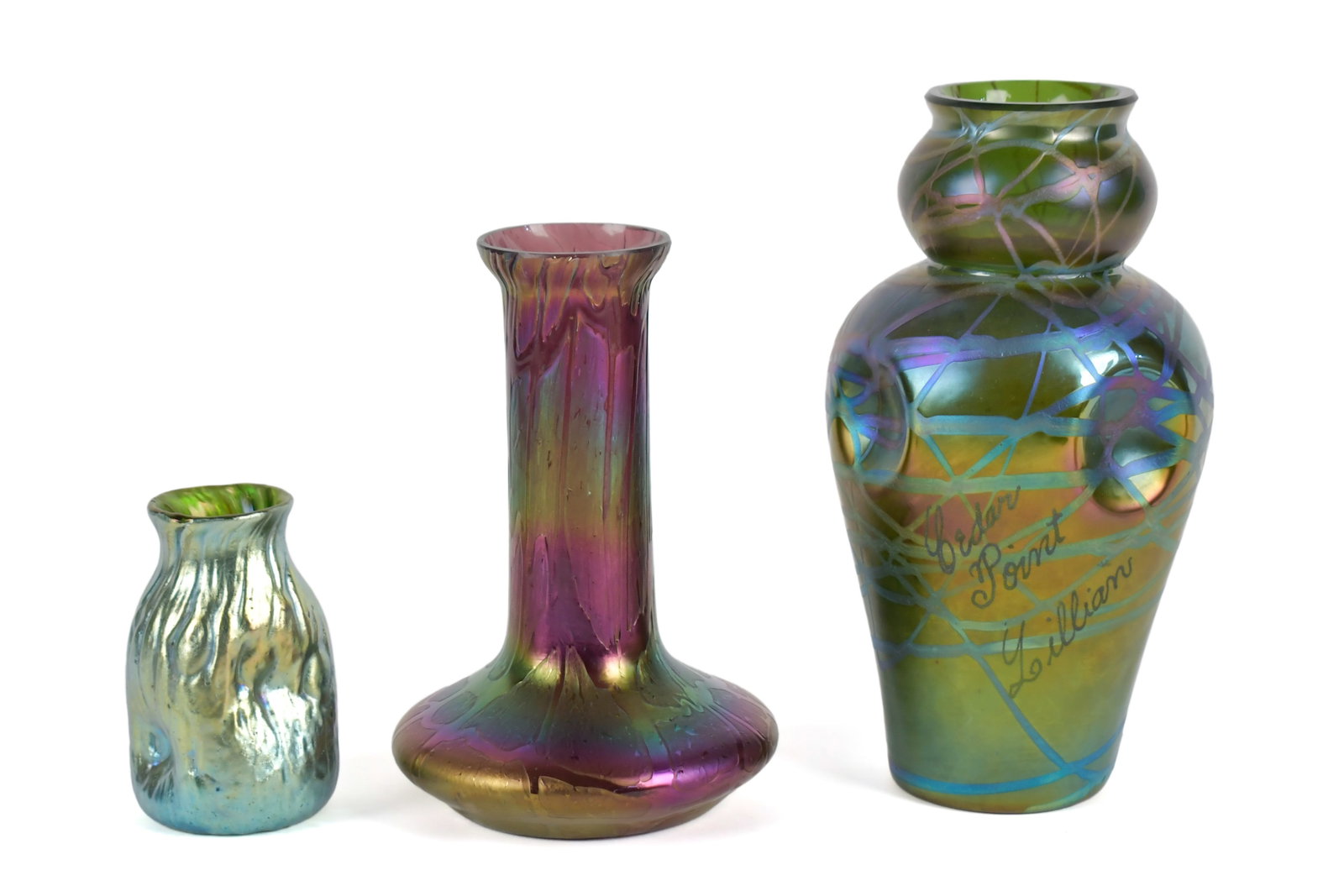 THREE ANTIQUE IRIDESCENT LOETZ VASES.: Three antique iridescent art glass vases attributed to Loetz. Smallest example with pinched form 3.75”H, green and purple squat form 6.5”H, and largest example with inscription on side of