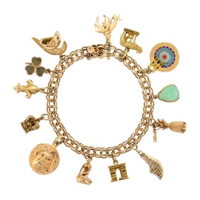 VINTAGE 14K GOLD TRAVEL INSPIRED CHARM BRACELET.