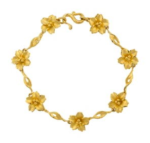 18K YELLOW GOLD PLUMERIA FLOWER BRACELET.