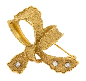 VINTAGE 18K GOLD DIAMOND TEXTURED BOW PIN.