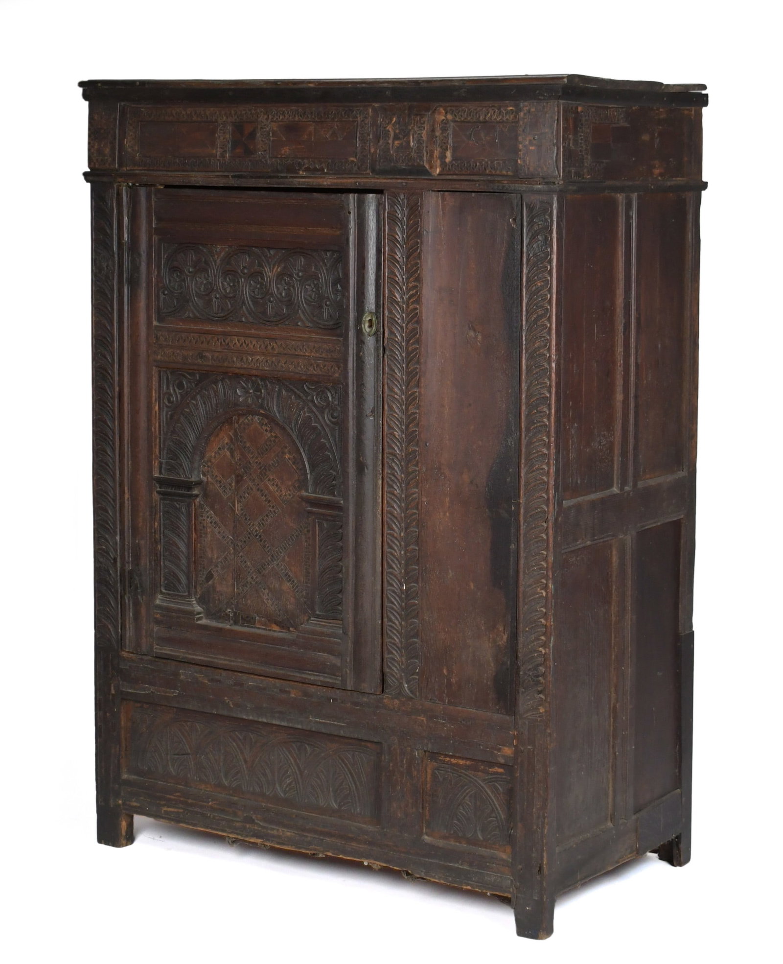 EARLY JACOBEAN CARVED COURT CUPBOARD.: An early carved and inlaid English Jacobean court cupboard, one paneled door with elaborate inlays and carvings. 61”H x 42.5”W x 24”D.