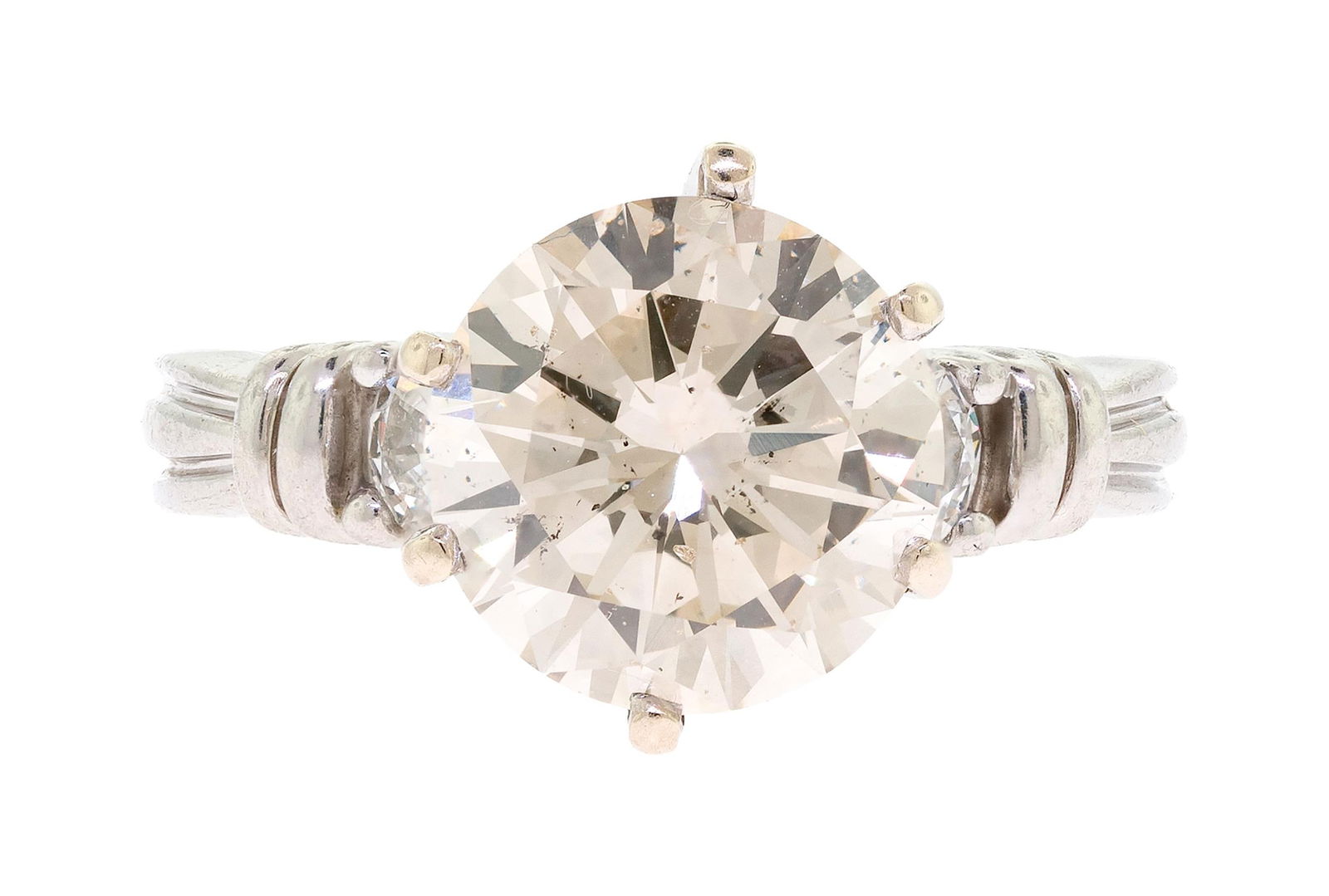 PLATINUM 2.6 CT. DIAMOND ENGAGEMENT RING.: A platinum (stamped) engagement ring set with approx. 2.6 ct., round brilliant cut, natural diamond of light brown color and I1 clarity, measuring 9.24 x 9.23 x 5.5mm (approx. depth, unable to get