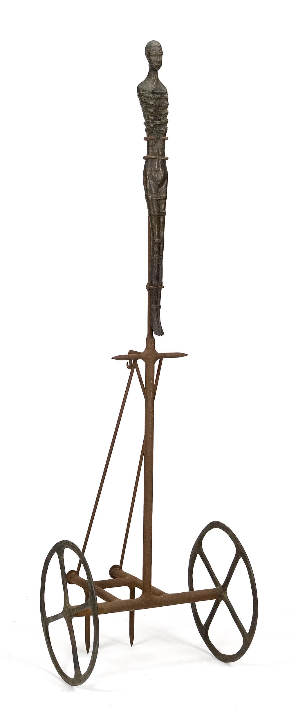 DAVID KOTKER SCULTPURE, CART WITH EPHESUSIAN FIGURE.: A David Kotker (1961-2005) bronze and metal sculpture, Cart with Ephesusian Figure. Includes original receipt. 71”H x 21”W base. Provenance: a Center Harbor, NH, Collection.