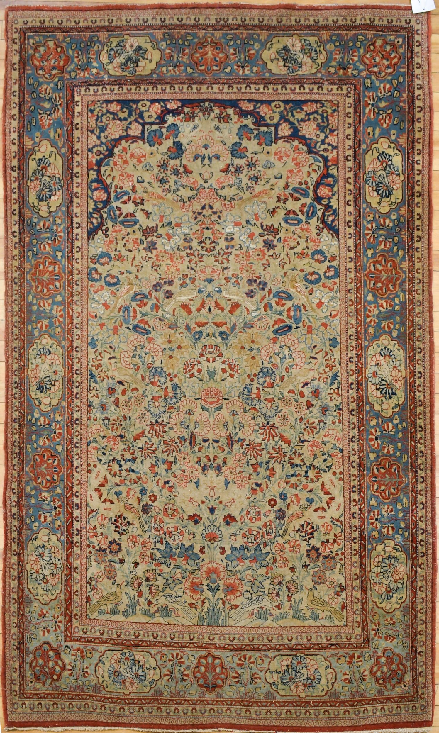 ANTIQUE ORIENTAL TURKISH PRAYER RUG.: An antique Oriental Turkish prayer rug, with elaborate floral, fruit and bird motifs, with light blue border. 4’3” x 6’9”.