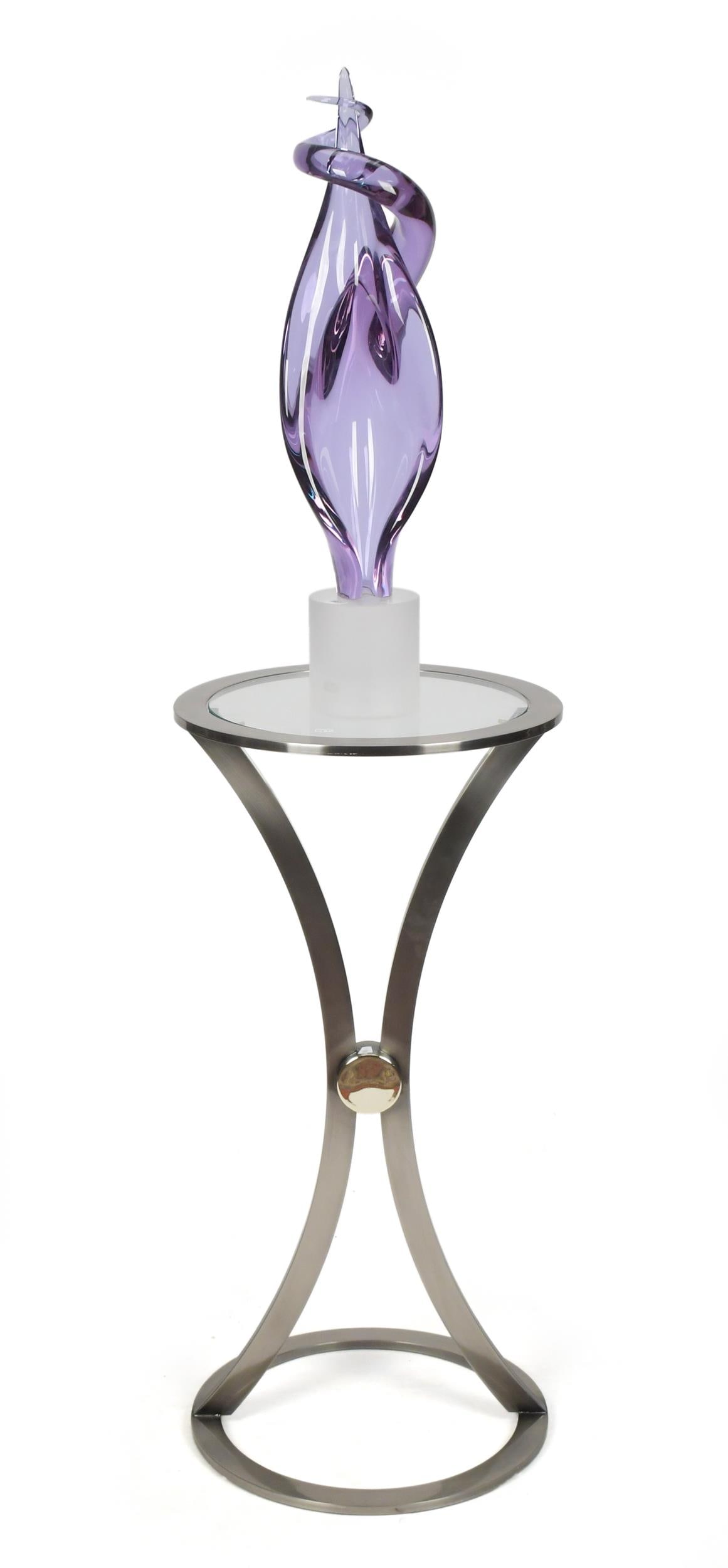 ELIO RAFFAELLI FOR ARS MURANO GLASS SCULPTURE.: A vintage Ars Murano glass sculpture by Elio Raffaelli, ‘Venus Rising’ with a custom chrome and glass pedestal/ stand.Sculpture 28”H, Stand 36”H x 17.5”dia.