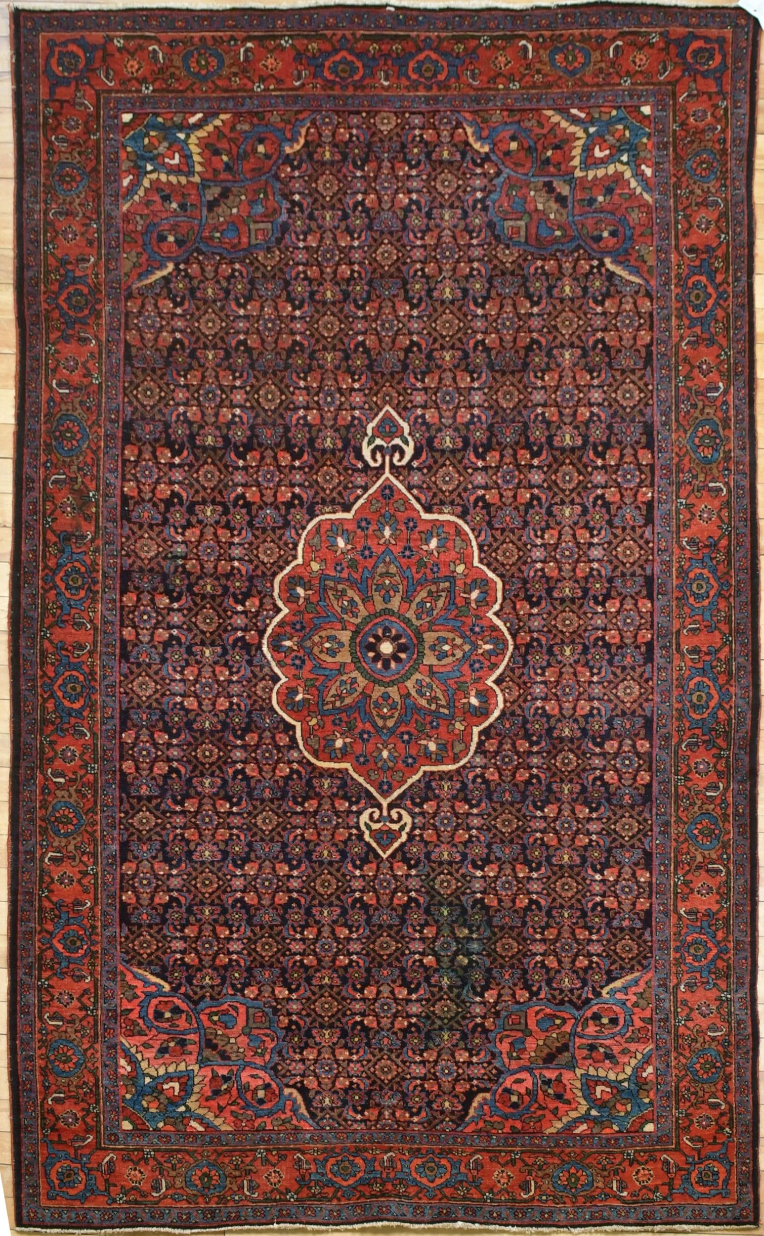 VINTAGE ORIENTAL SCATTER RUG.: A vintage Oriental scatter rug, with central maroon medallion on dark blue ground, with red border. 4’5” x 6’9”.