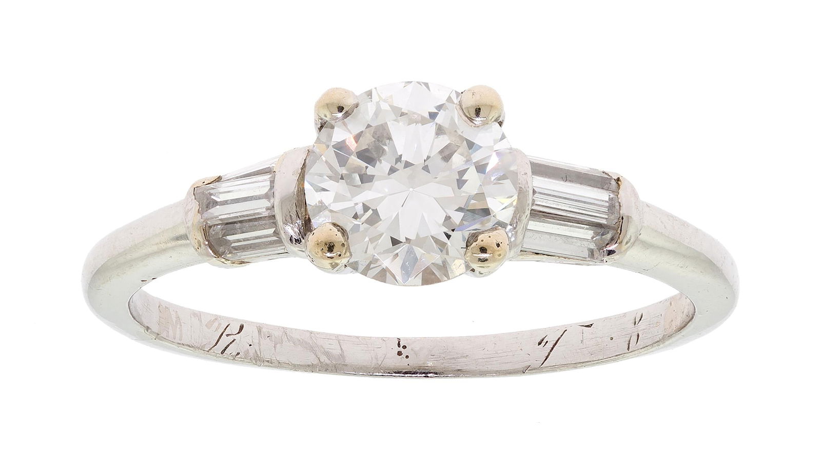 VINTAGE PLATINUM DIAMOND ENGAGEMENT RING.: A vintage 1936, platinum (tested) engagement ring, set with an approx. .75 ct., transition cut, natural diamond of J-K color and VS clarity and approx. .25 ct. tw. baguette cut, natural diamonds of