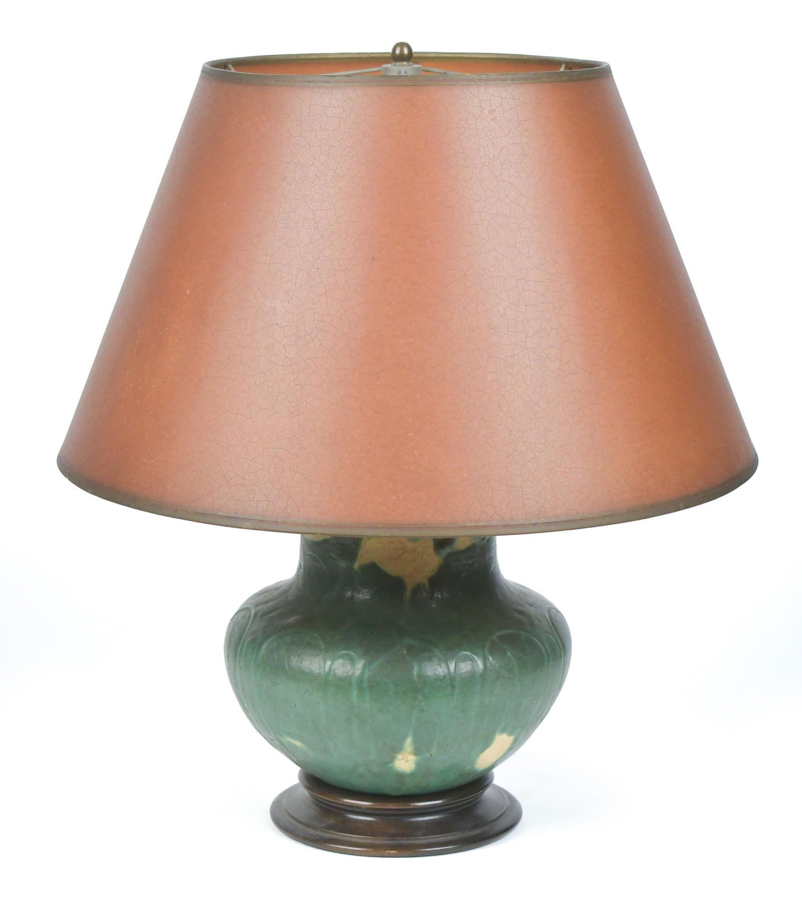 GRUEBY POTTERY GREEN GLAZED LAMP.: An early 20th C. Grueby Pottery lamp in green glaze, with lightly incised arches, unsigned. Mounted to wood base. Pottery 7”H x 18”H overall.