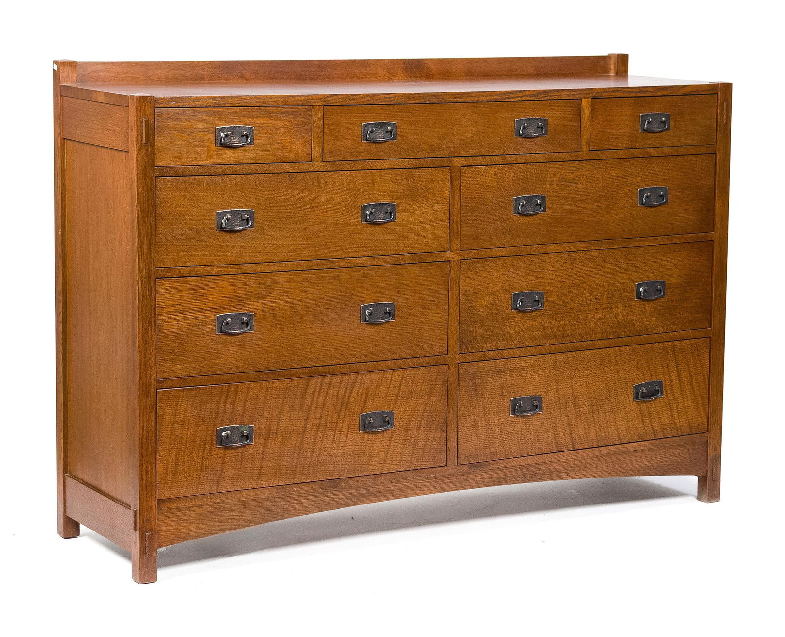 20TH C. STICKLEY MISSION OAK DRESSER.: A vintage 20th C. Arts & Crafts Stickley (Manlius, NY) branded and labeled nine drawer tall chest, with original hand hammered hardware and through-tenon construction. 46.5”H x 66”W x 20&#