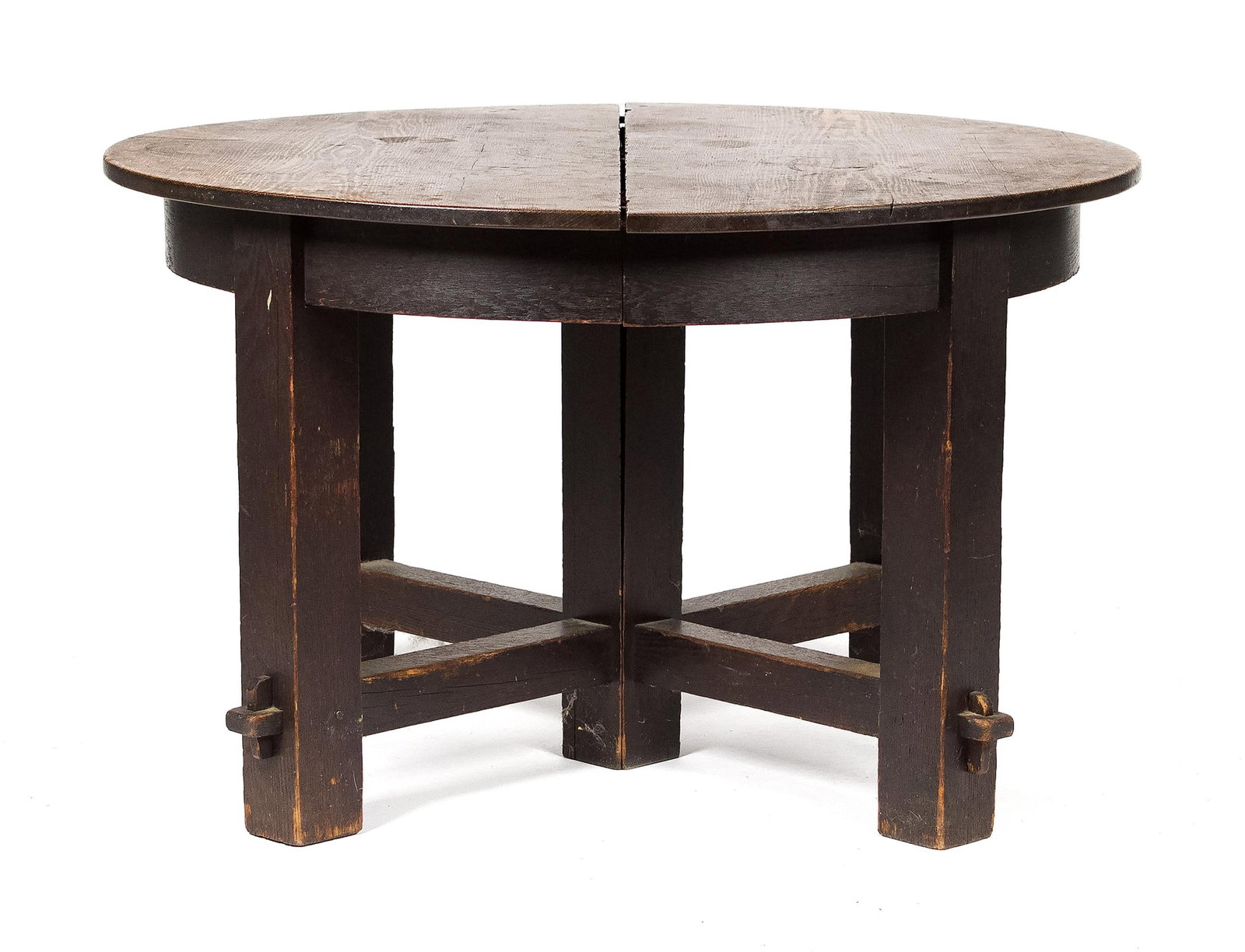 ANTIQUE ARTS & CRAFTS EXTENDING DINING TABLE.: An antique Mission oak extending dining table in old finish, with through tenon construction, no makers labels or markings. 28.5”H x 48” dia. Includes (5) 10”W leaves in original rac