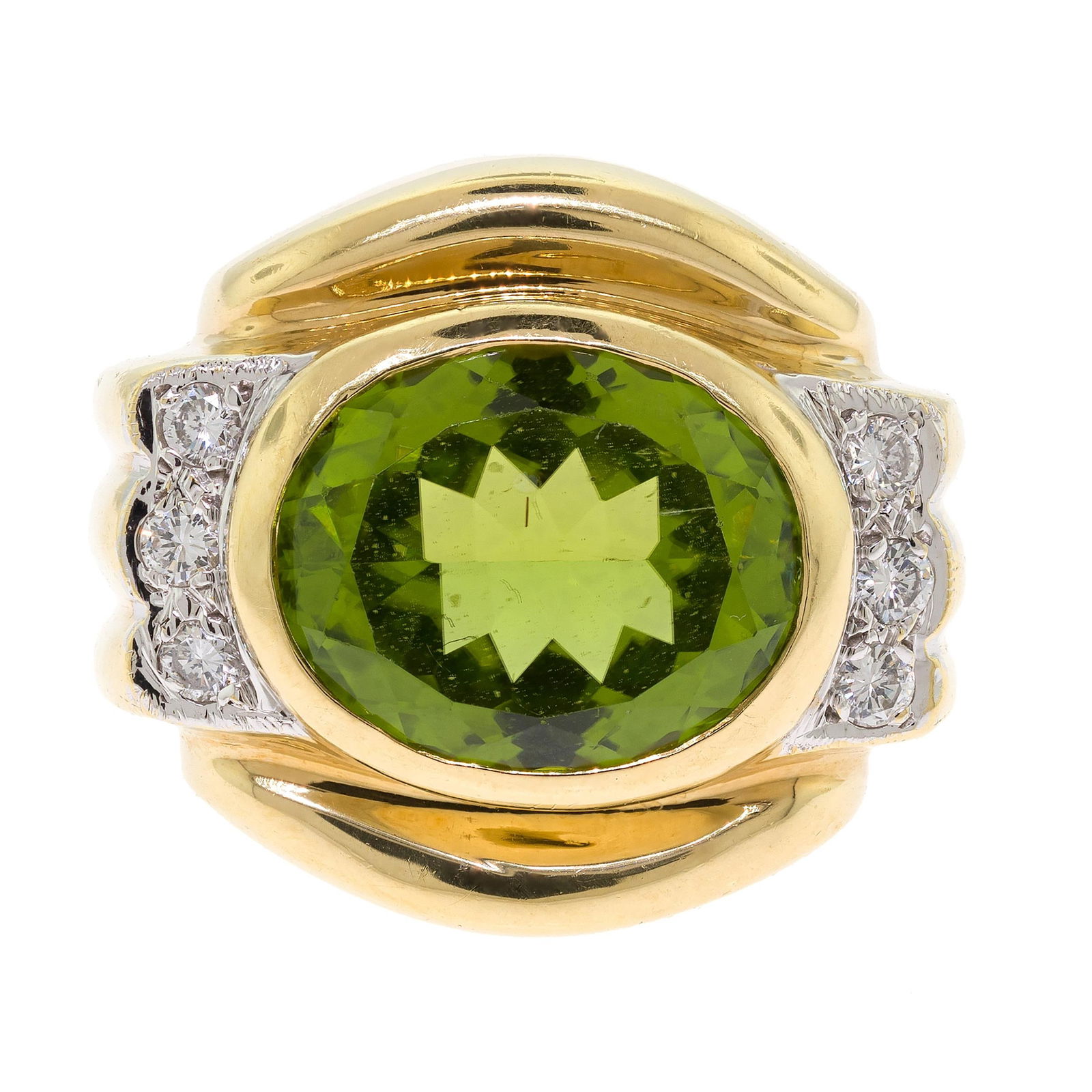 18K GOLD PERIDOT & DIAMOND RING.: An 18k yellow gold (tested) ring set with an approx. 7.5 ct., faceted oval, medium dark, yellowish green peridot and approx. .30 ct. tw., round brilliant cut, natural diamonds of G-H color and VS-SI