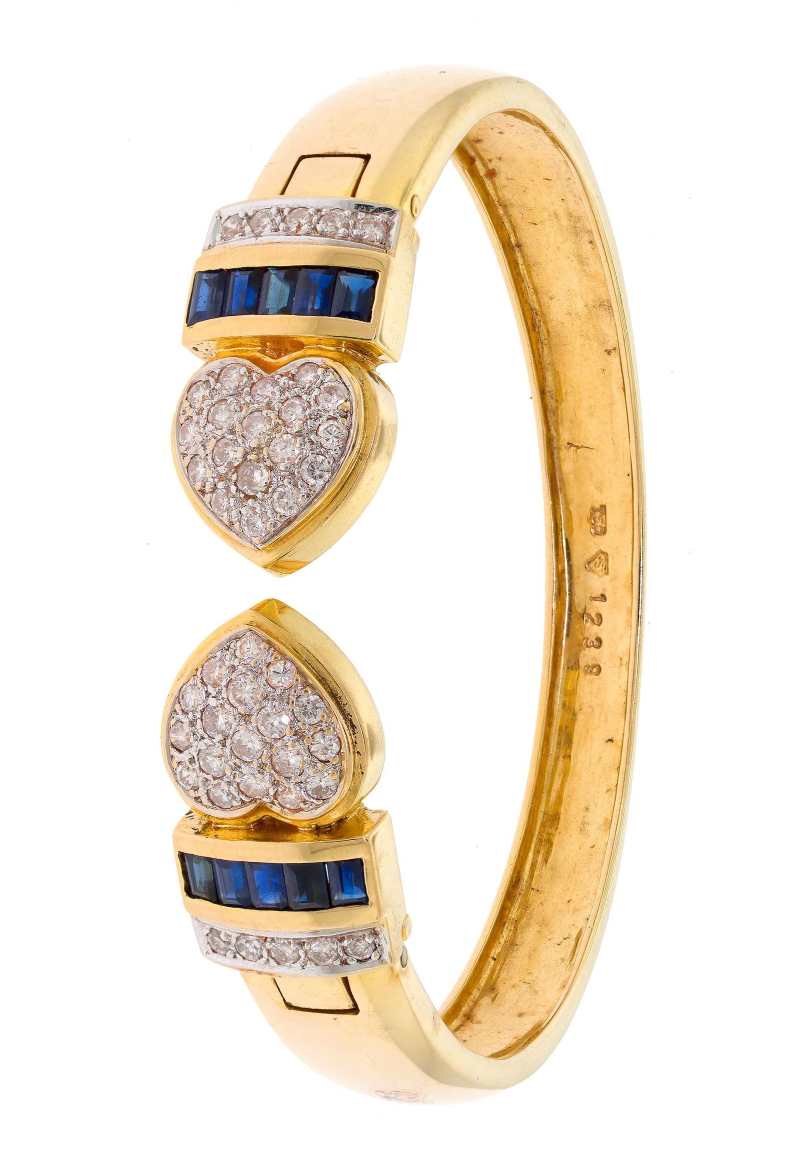 18K GOLD SAPPHIRE & DIAMOND HEART BANGLE BRACELET.: An 18k yellow gold (stamped) heart bangle/cuff bracelet set with approx. 2.5 ct. tw., round brilliant cut, natural diamonds of H-I-J color and SI clarity and baguette cut dark blue sapphires, 12mm