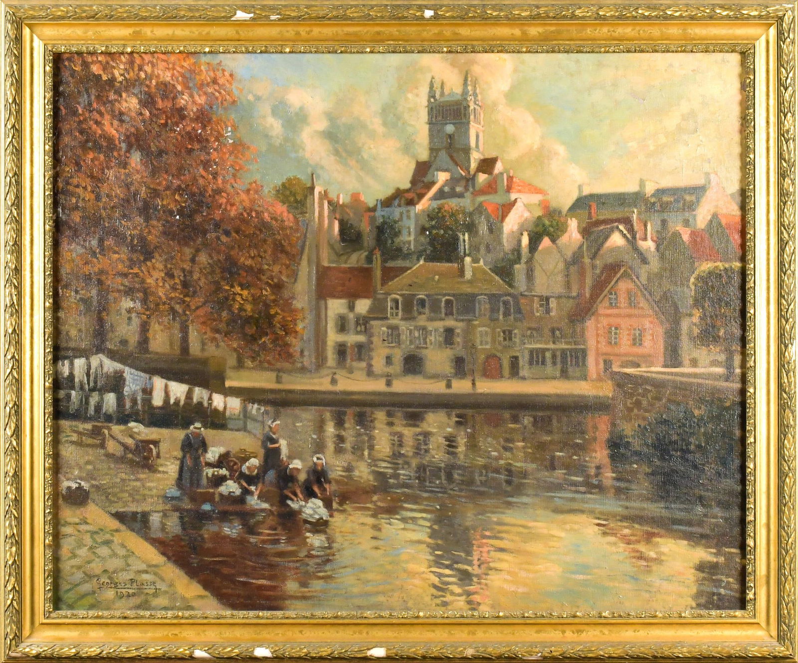 GEORGES PLASSE OIL ON CANVAS, RIVERSIDE VILLAGE.: A Georges Plasse (b. 1878) oil on canvas, figures washing laundry at a river’s edge, signed lower left, Georges Plasse 1920. Frame 37” x 44.5”.